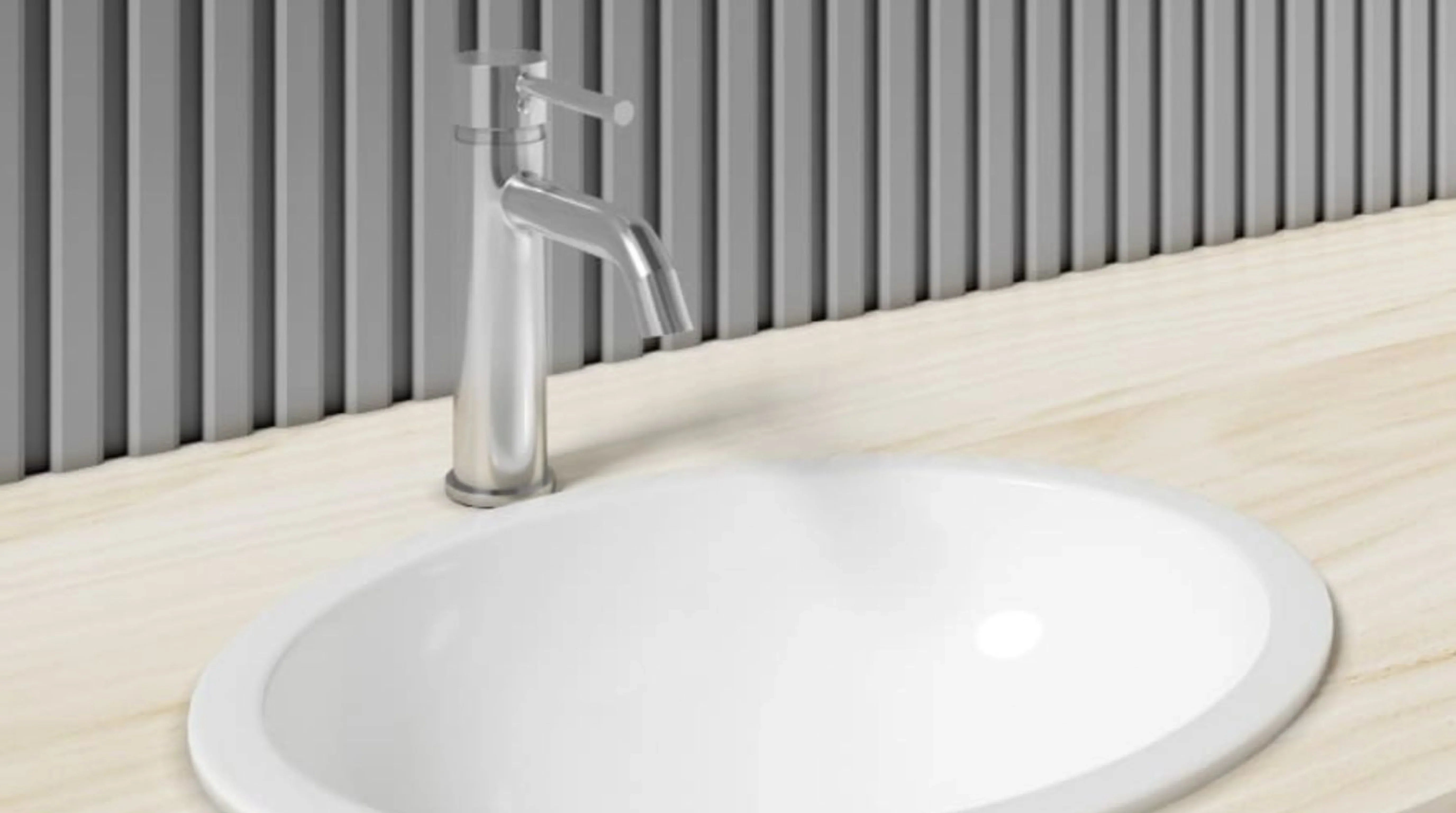 Image of Modern chrome bathroom faucet installed on a wooden countertop with a white oval sink