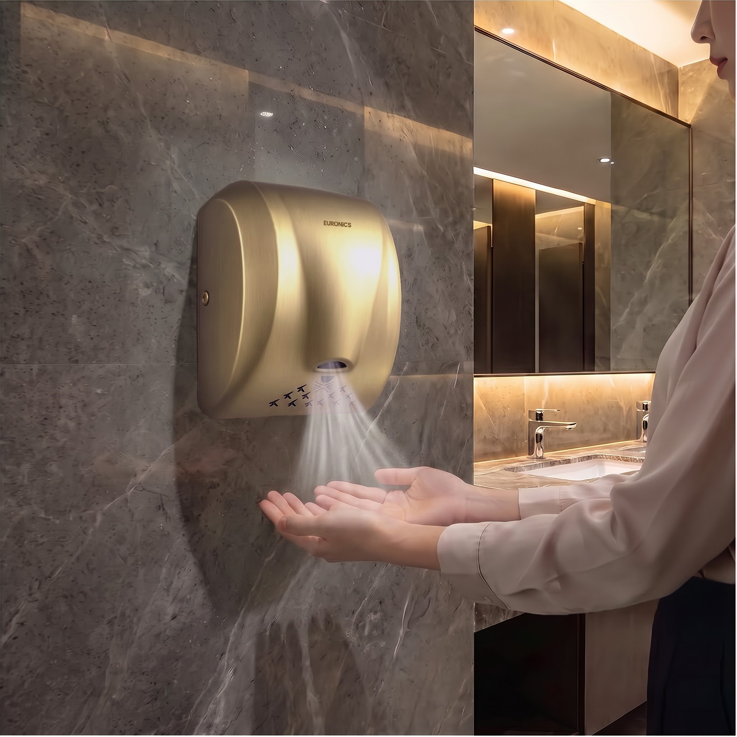 Image of Euronics Industries EH210N gold stainless steel hand dryer in use in a luxury washroom