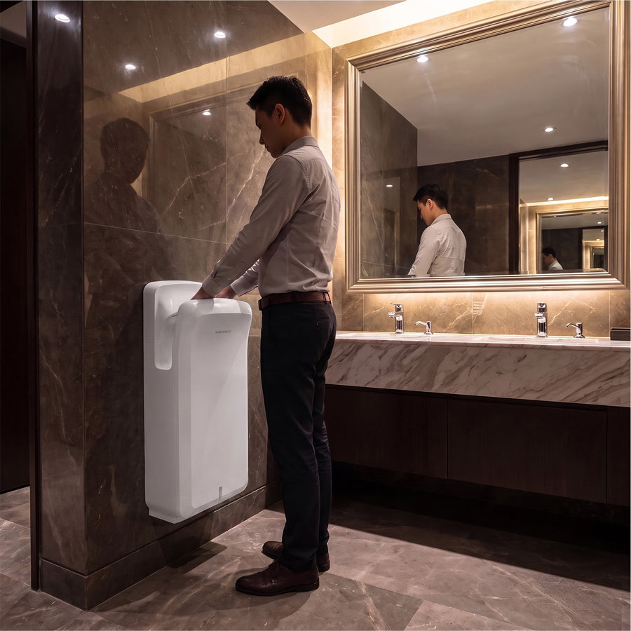 Image of A man using a white Euronics Industries high-traffic ABS hand dryer in a luxury washroom.