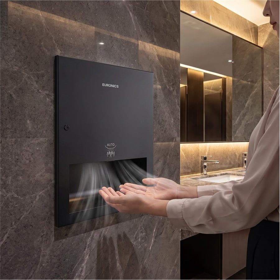 Image of Woman using a recessed black Euronics Industries hand dryer in a modern washroom
